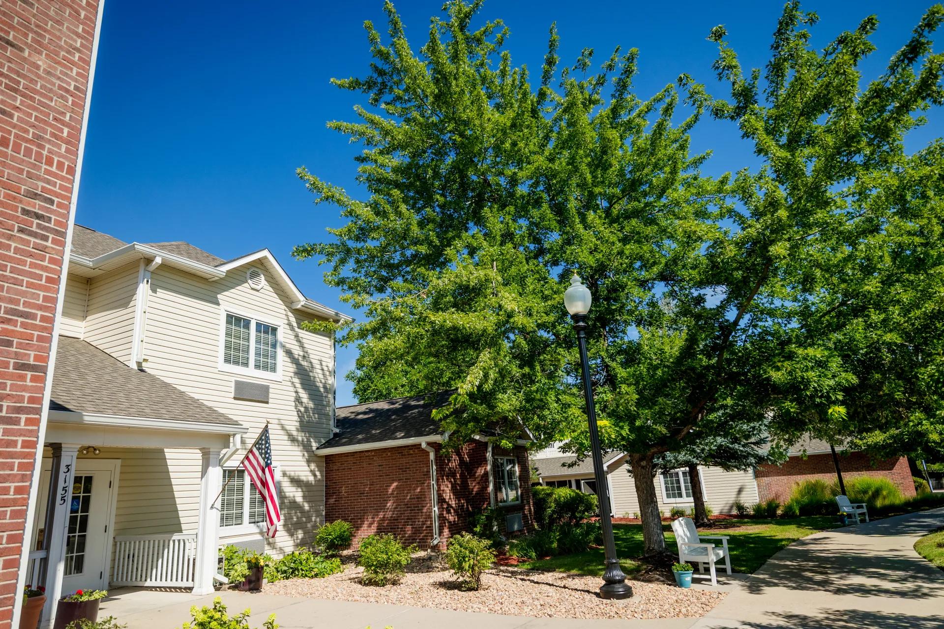 Tree-lined walkway and landscaped courtyard between Bear Creek residential buildings