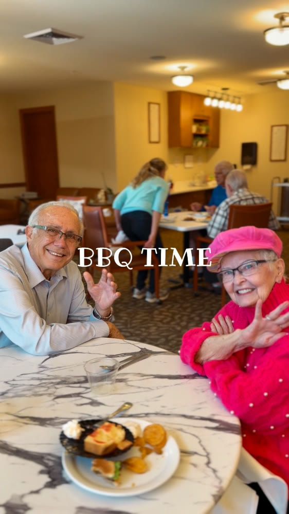 Two Gardens on Quail residents smile together at a community BBQ table; the image includes a BBQ Time caption.
