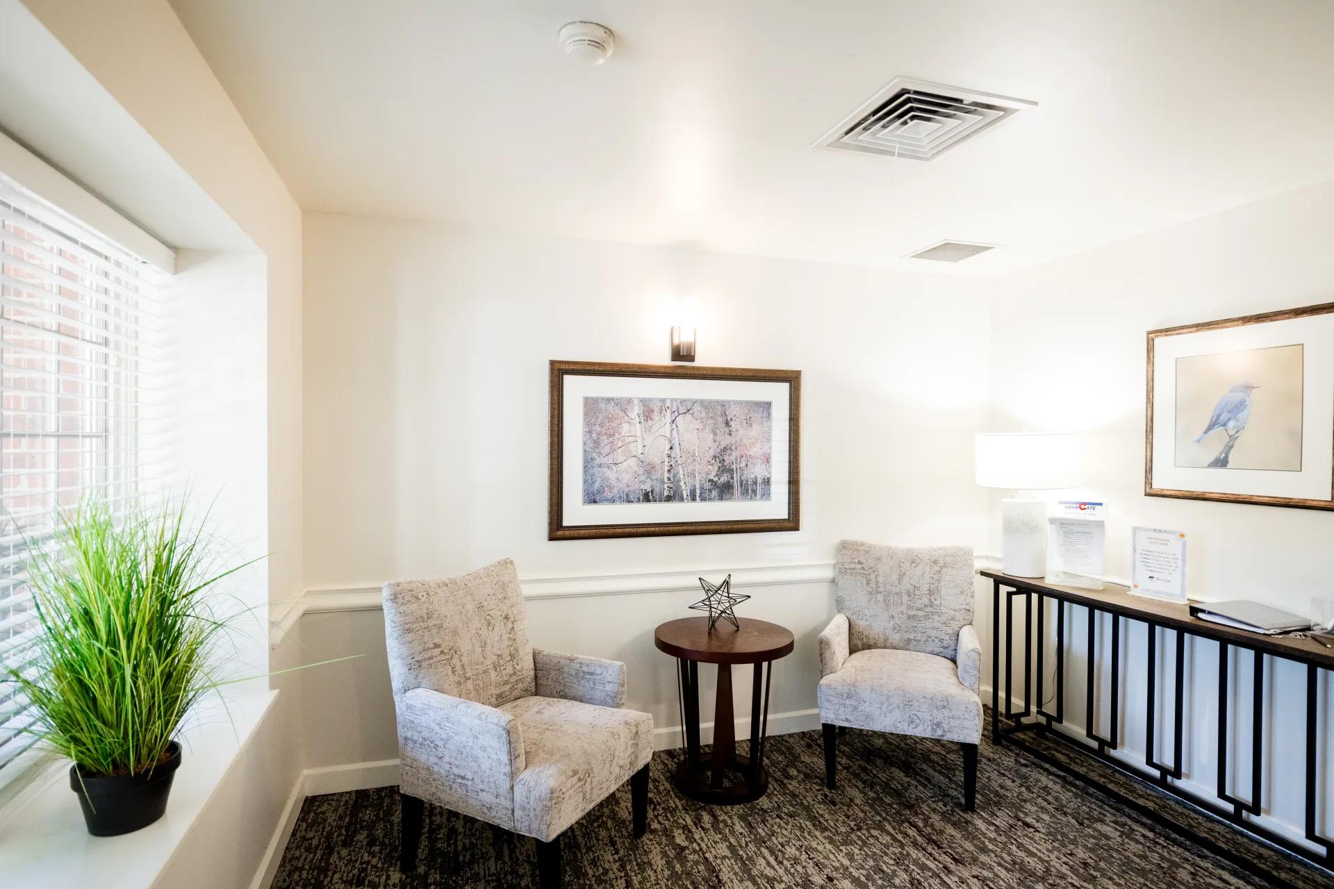 Two upholstered chairs beside a window in an upstairs Bear Creek sitting area
