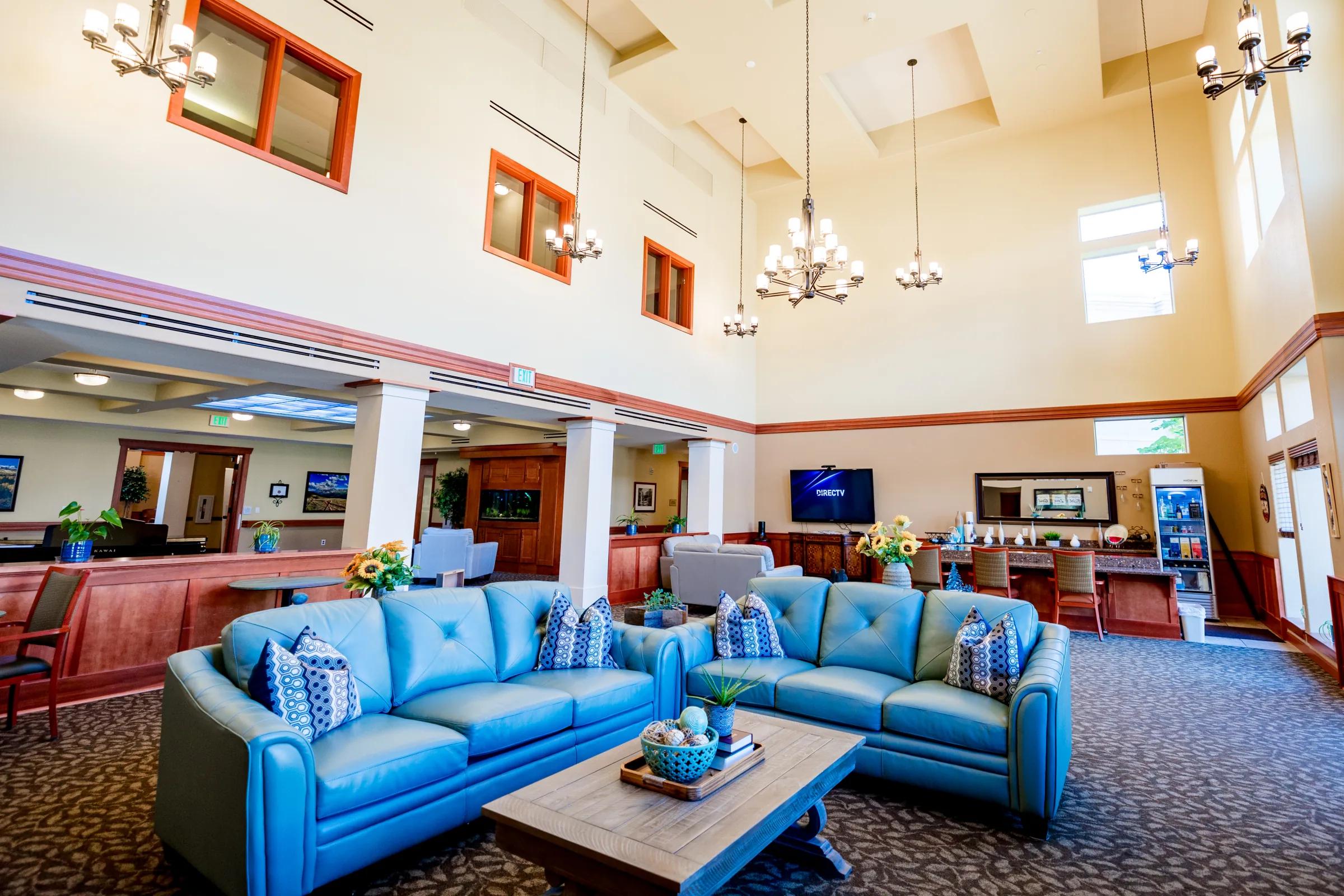 Gardens on Quail main lobby with twin blue leather sofas and cathedral ceiling