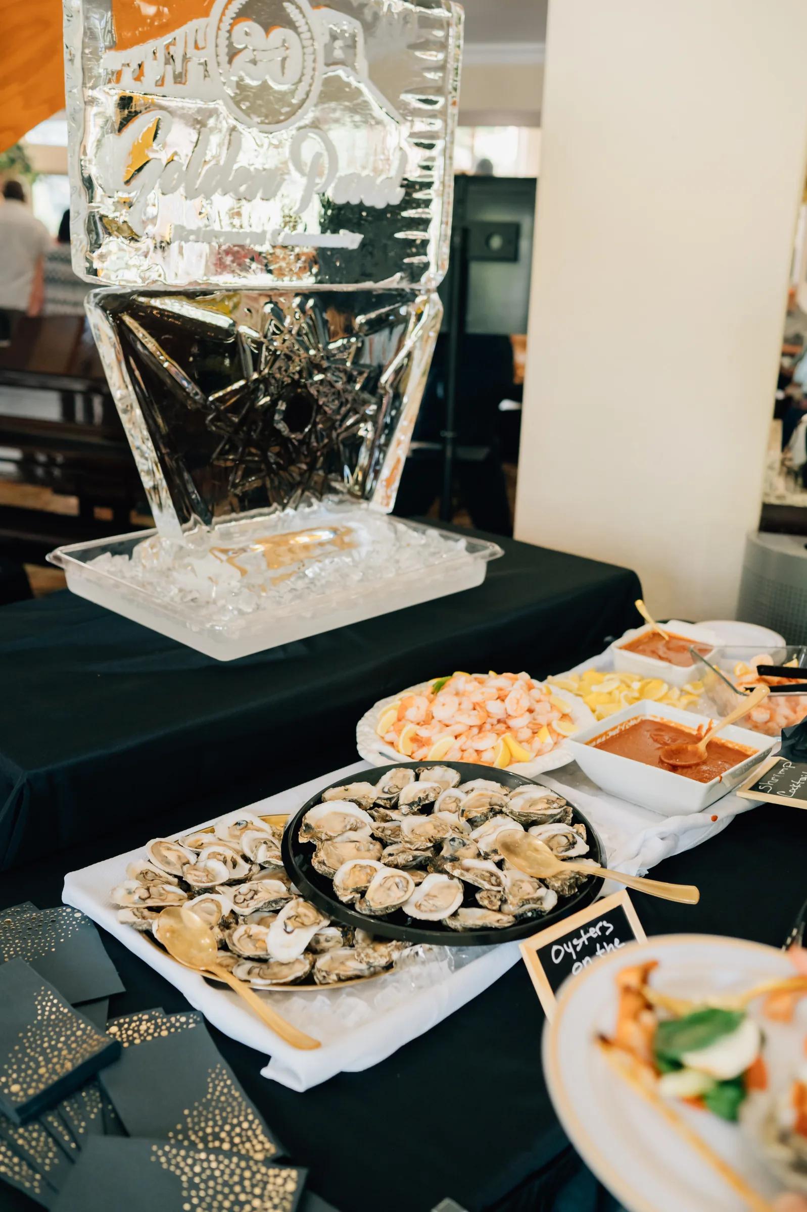 Golden Pond gala buffet with custom ice sculpture and fresh oyster display