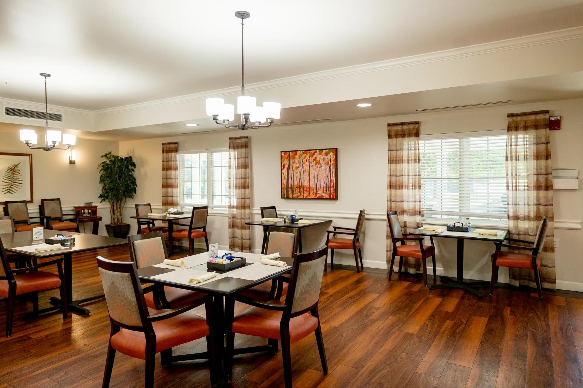 Tables and chairs arranged in the bright Bear Creek dining room
