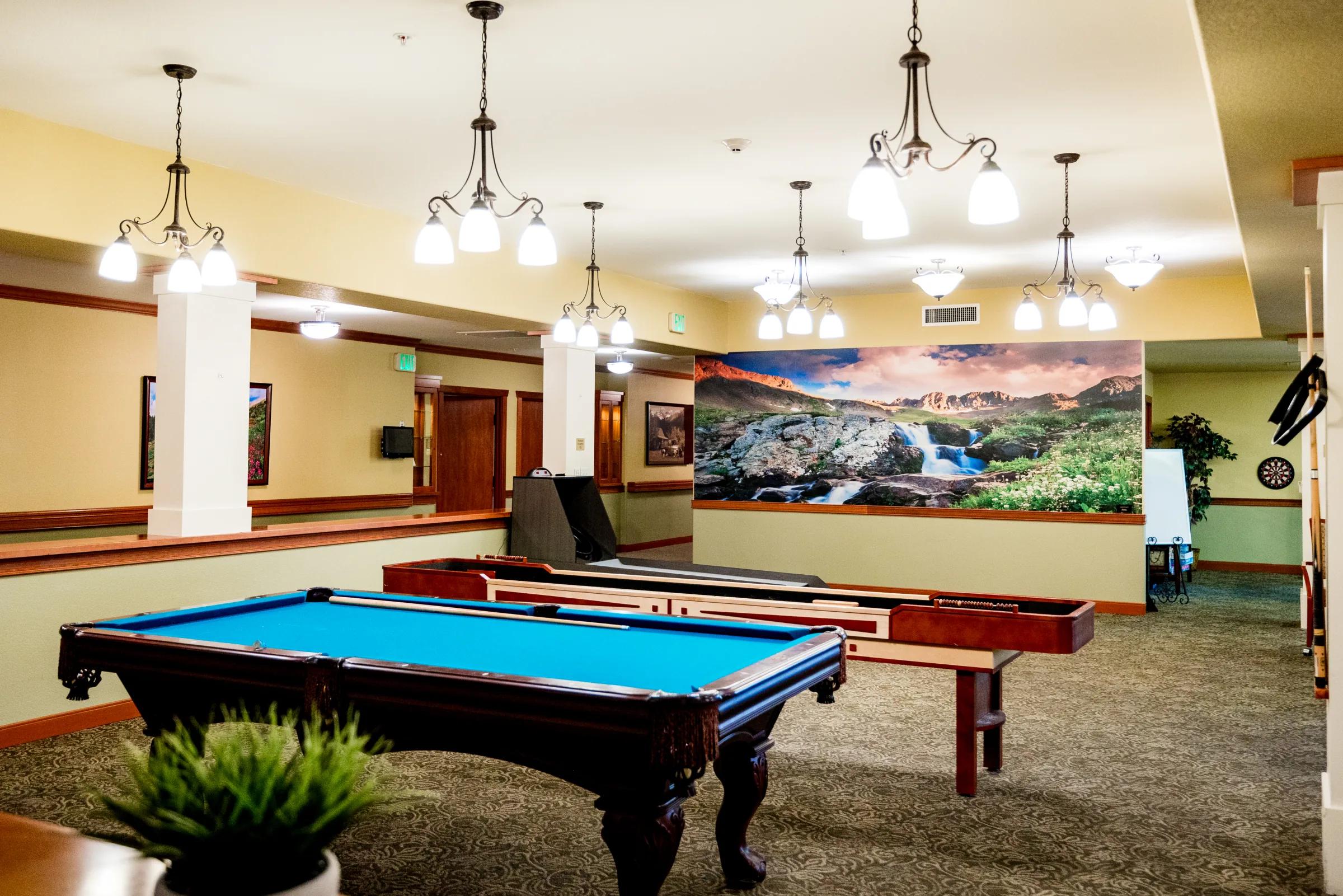 Gardens on Quail billiards room with pool tables and Colorado landscape mural