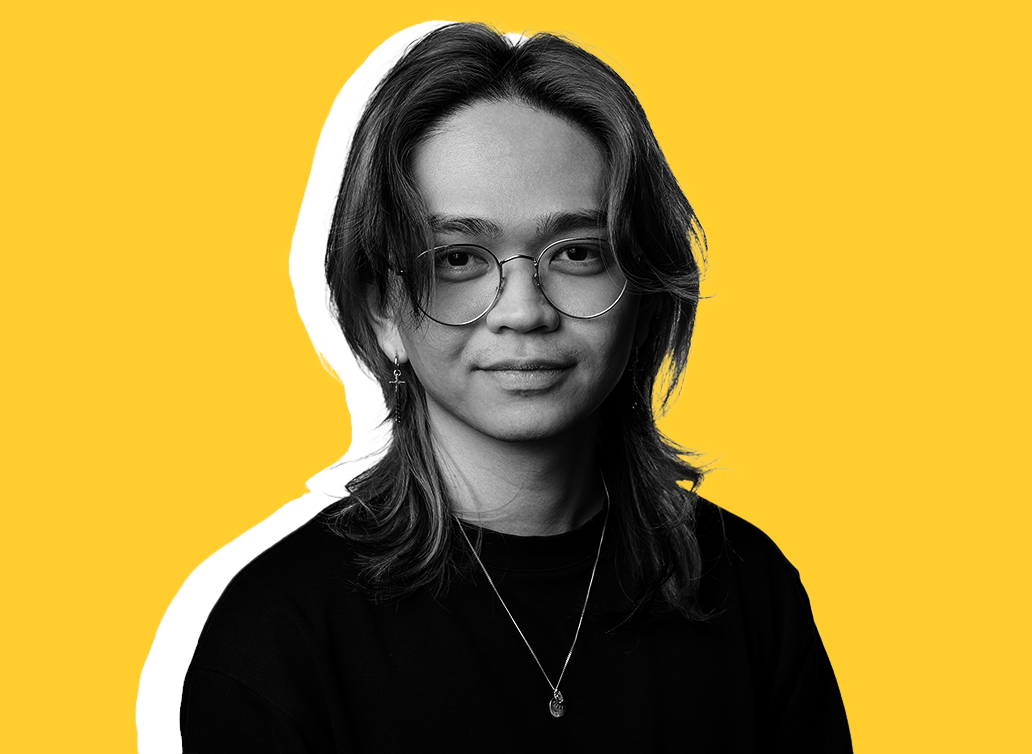 Miguel staff photo with yellow background