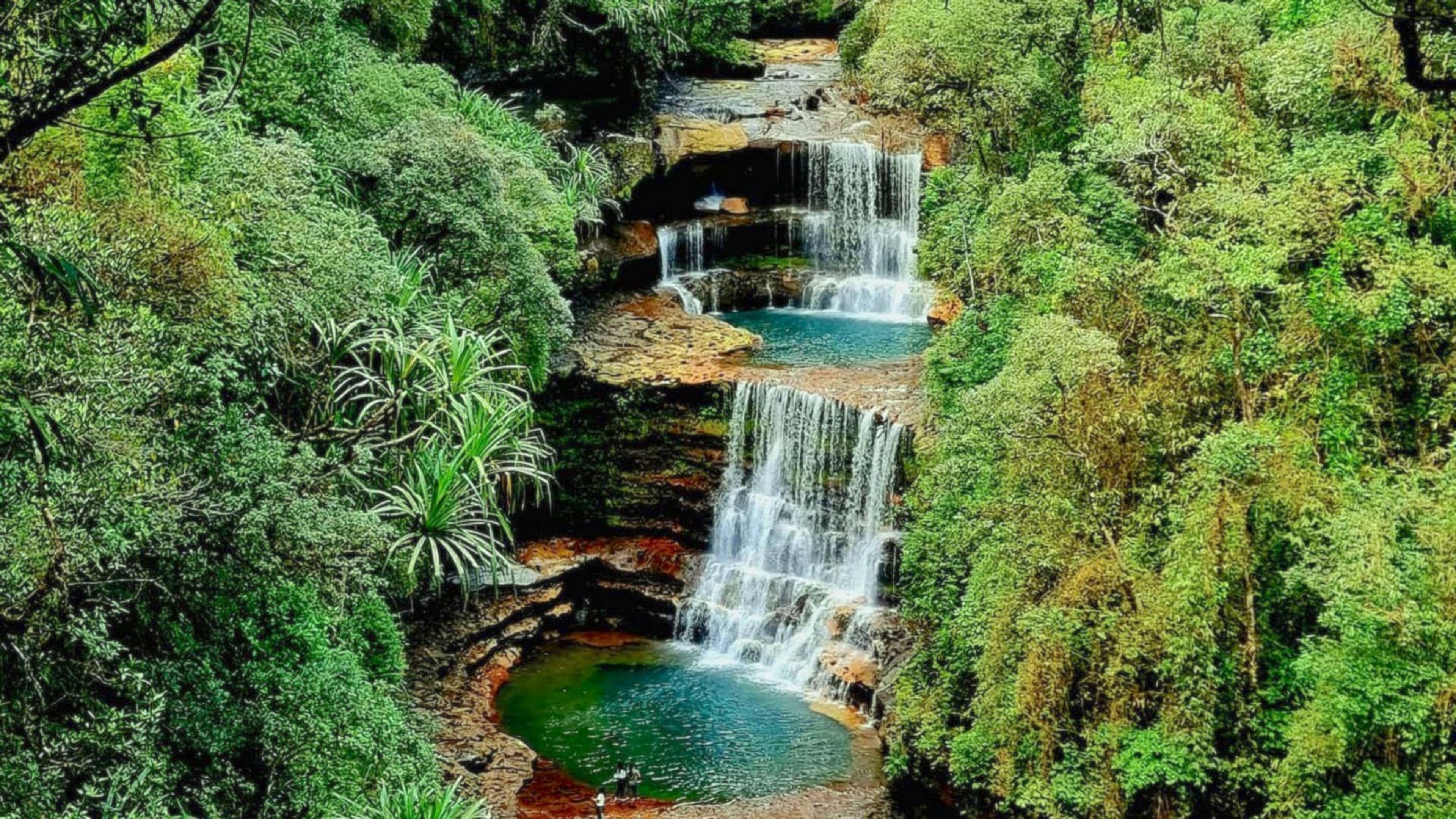 The three tiers and blue pools of Wei Sawdong Falls near Cherrapunji