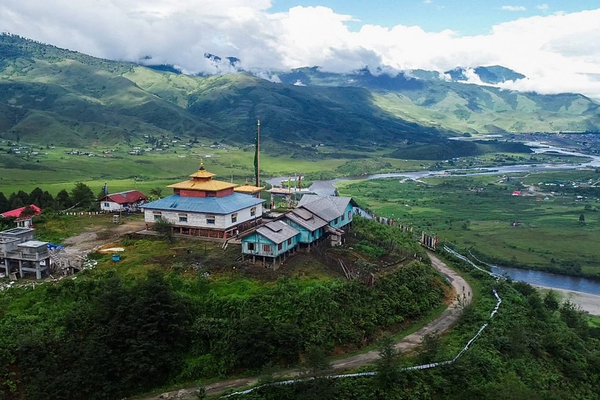 Alt-Text: > A panoramic view of the eco-friendly bamboo stages at the Ziro Valley Music Festival 2026 in Arunachal Pradesh, surrounded by the UNESCO-recognized Apatani terraced rice fields.