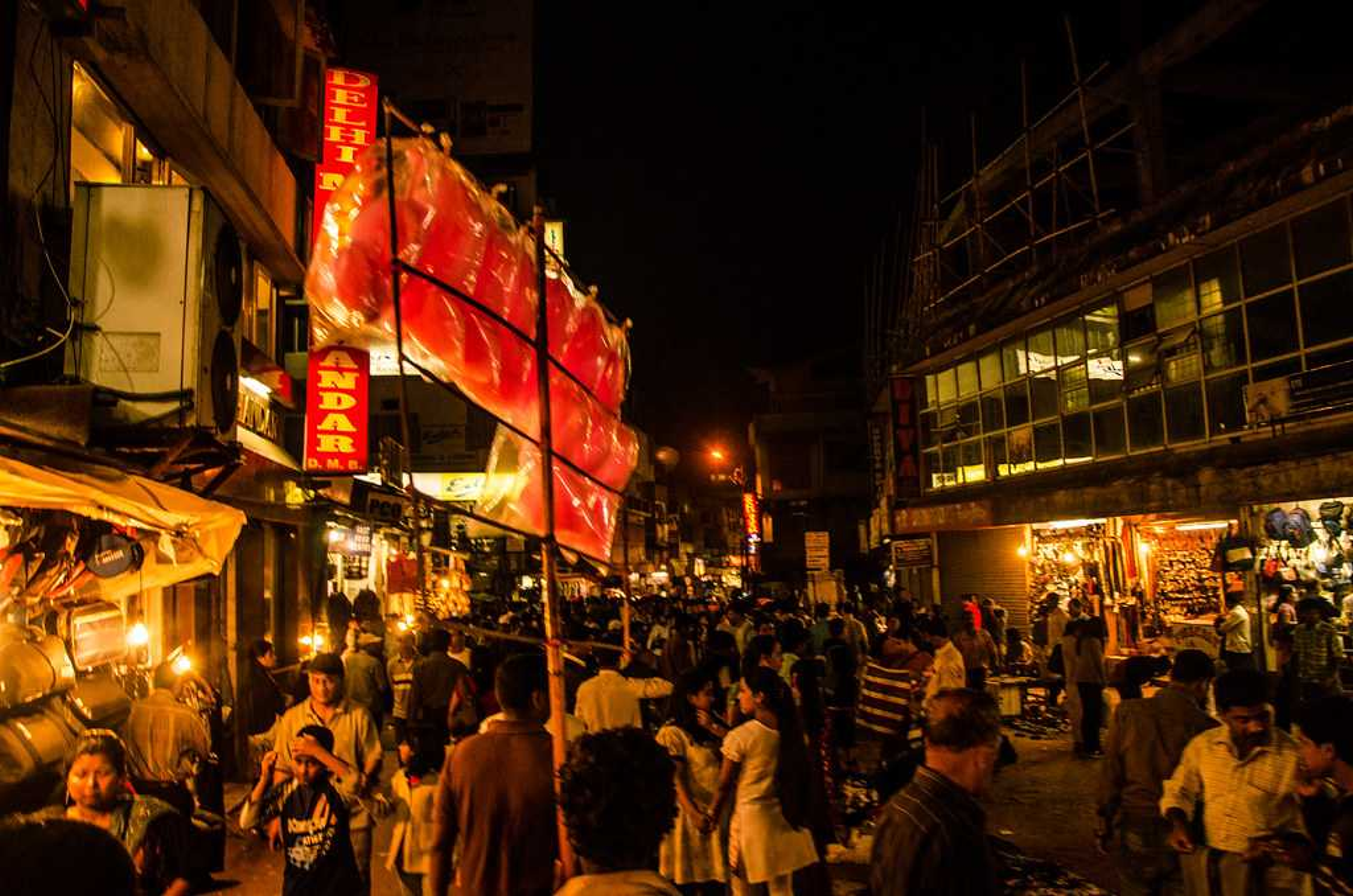 A bustling street scene in Police Bazar, Shillong, with various food stalls and shops.