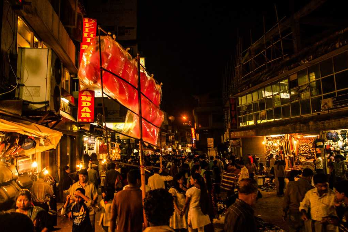 A bustling street scene in Police Bazar, Shillong, with various food stalls and shops.