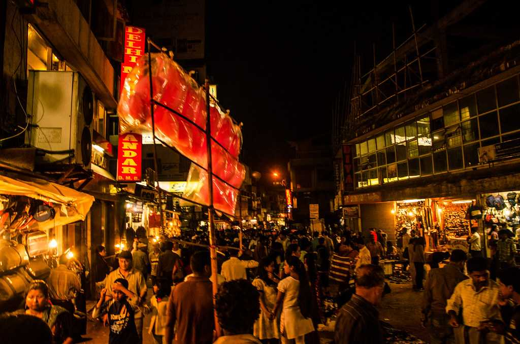 A bustling street scene in Police Bazar, Shillong, with various food stalls and shops.
