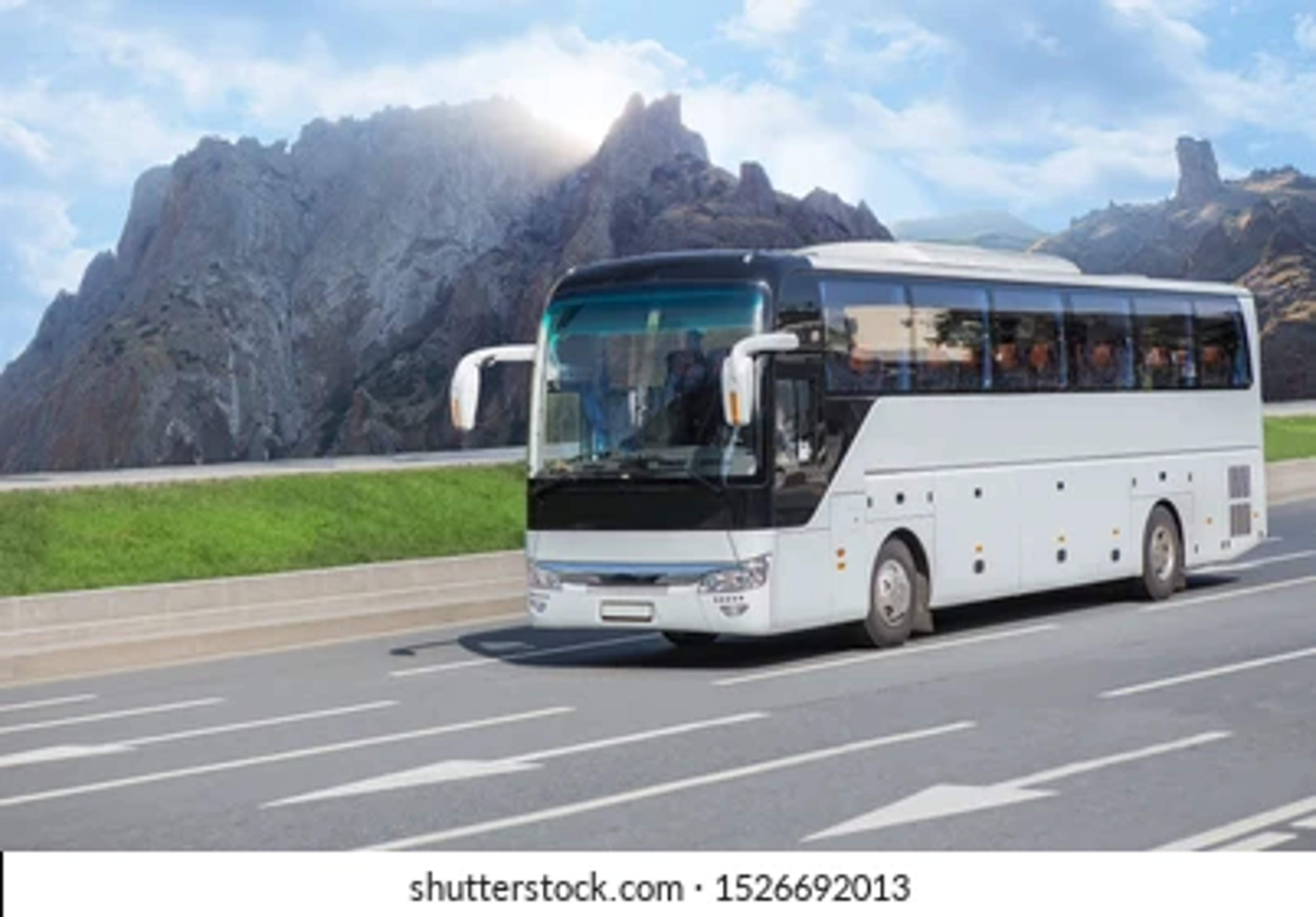 An air conditioned state transport corporation luxury tourist bus driving smoothly along a mountain highway curve