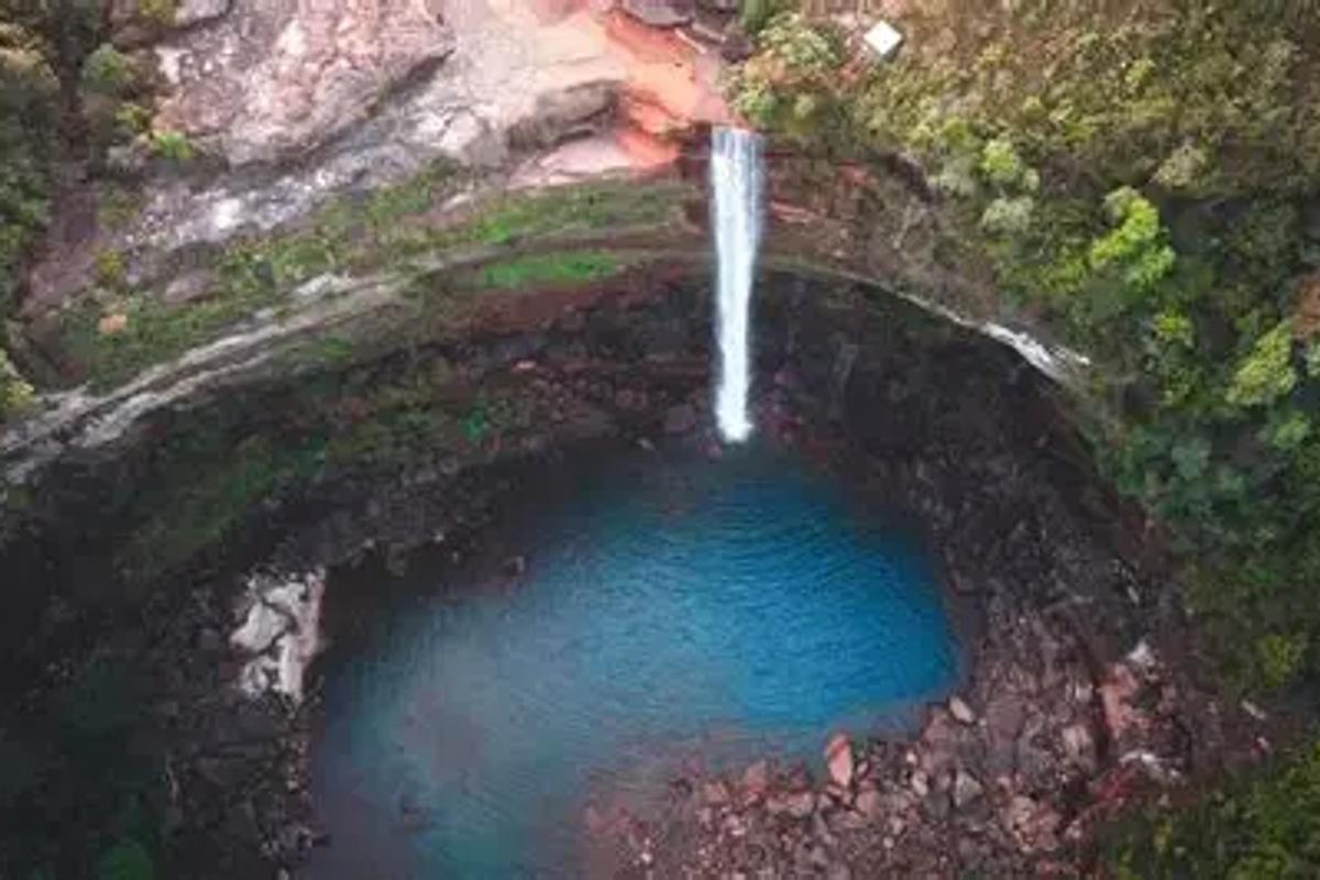 Double-drop Phe Phe Falls in West Jaintia Hills Meghalaya with a deep blue swimming pool.