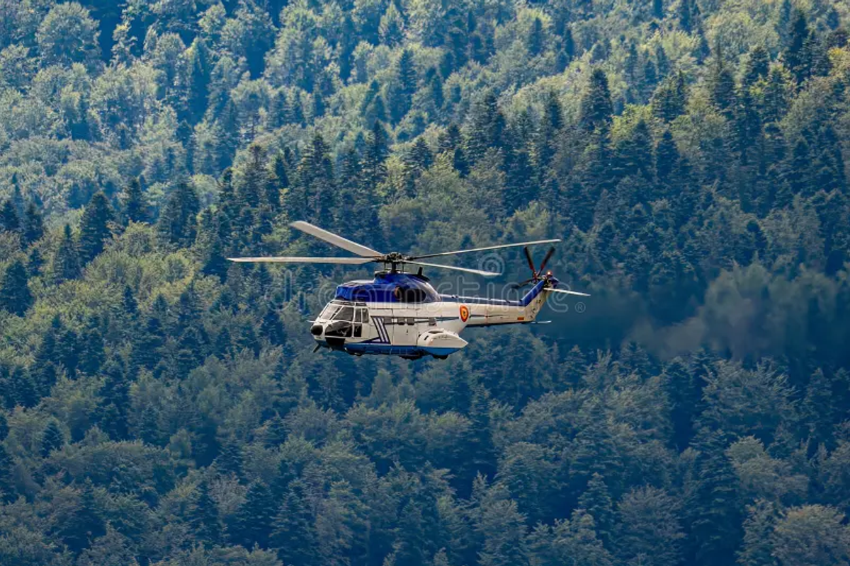 A Sikkim Tourism helicopter flying over the lush Himalayan foothills and the Teesta River valley.