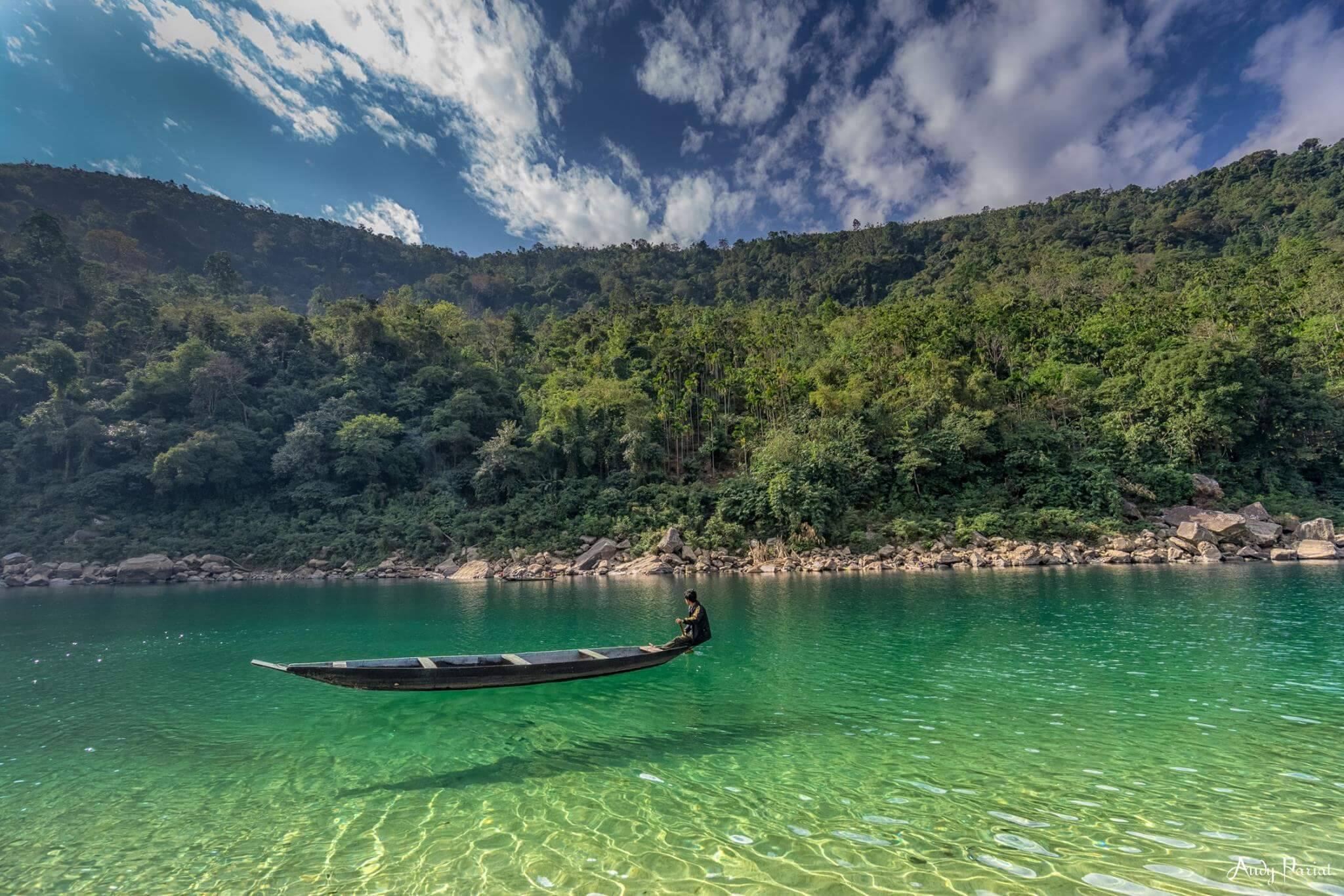 A single boat on the transparent water at Dawki