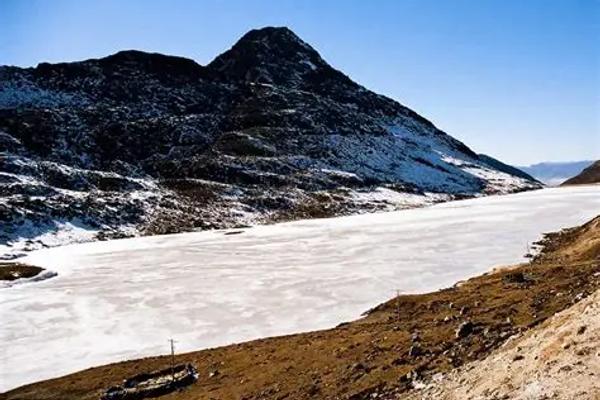 Colorful Sela Pass gateway with deep winter snow in Arunachal Pradesh.