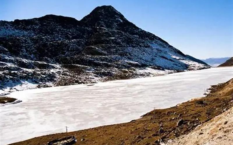 Colorful Sela Pass gateway with deep winter snow in Arunachal Pradesh.