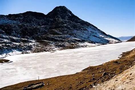 Colorful Sela Pass gateway with deep winter snow in Arunachal Pradesh.
