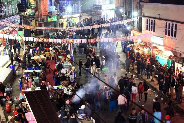 Kohima night bazaar during Hornbill Festival with lit food stalls and crowds