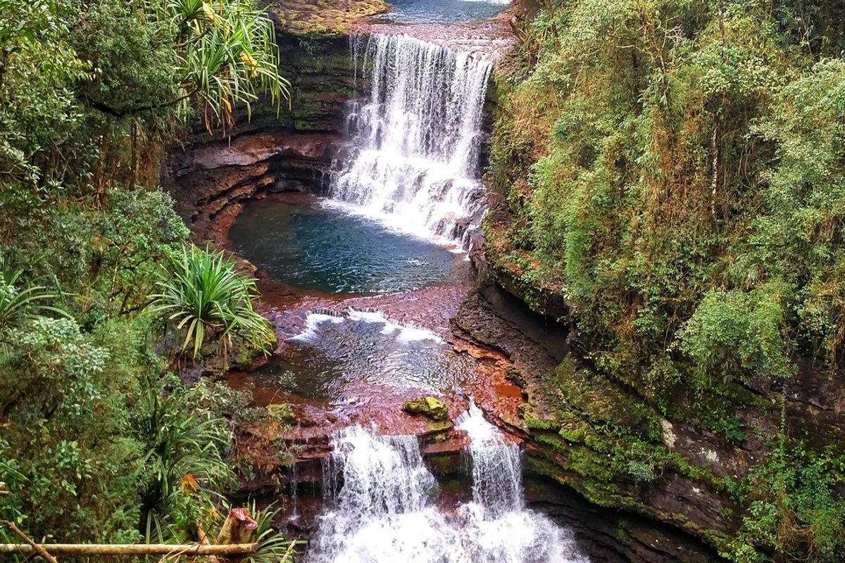 Wei Sawdong Falls with natural pool surrounded by dense forest in Cherrapunji, Meghalaya