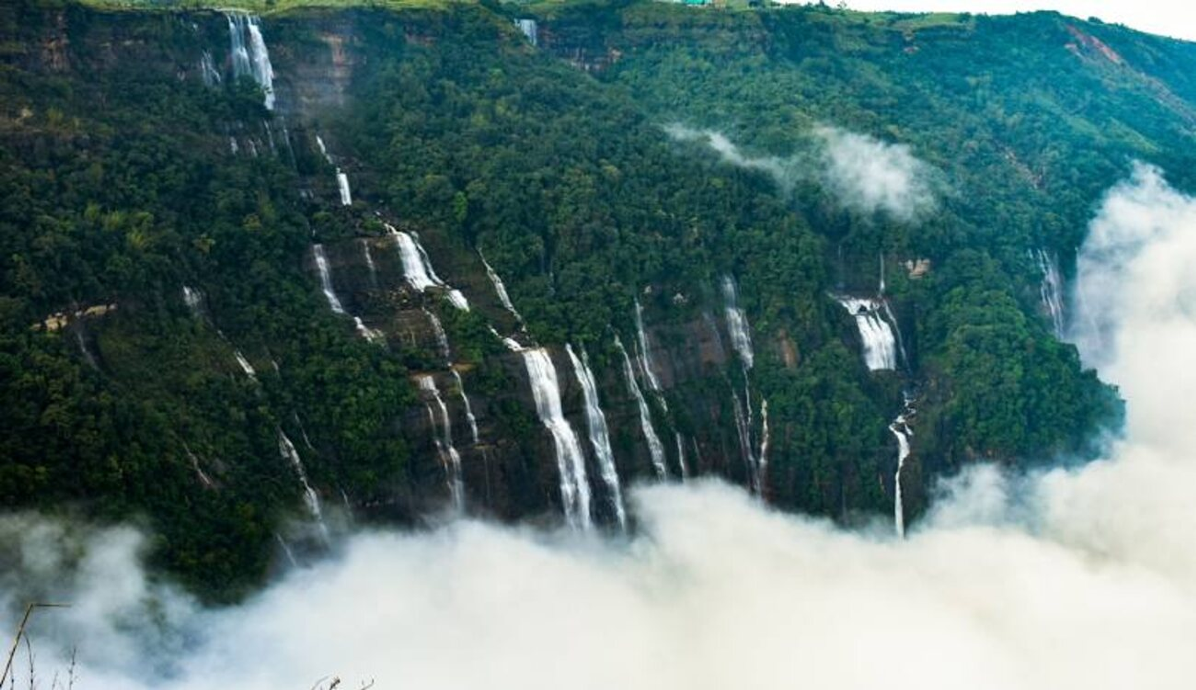 The thundering Nohkalikai Falls in Cherrapunji with a clear view of the plunge pool.