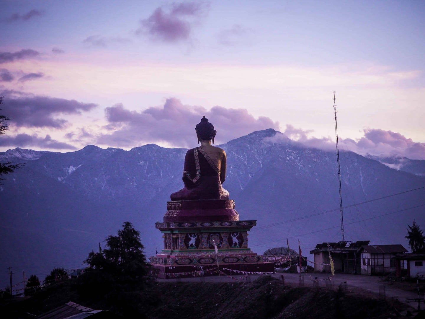 40-foot seated Buddha statue in Tawang overlooking the misty mountain valley at sunset.