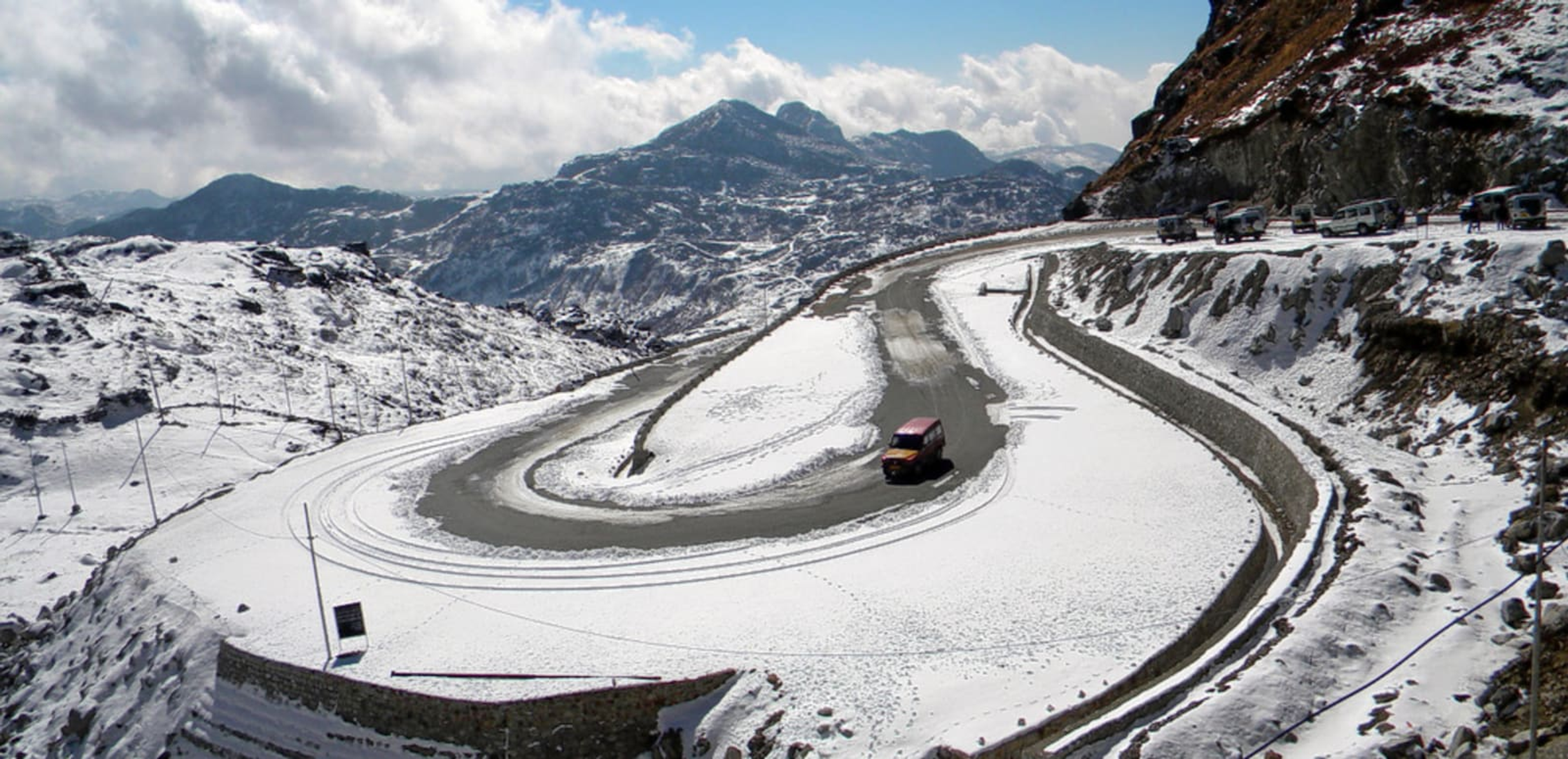 The Indo-China border gate at Nathu La Pass in Sikkim with snow-covered Himalayan peaks and military outposts