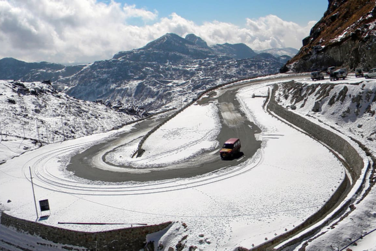 The Indo-China border gate at Nathu La Pass in Sikkim with snow-covered Himalayan peaks and military outposts