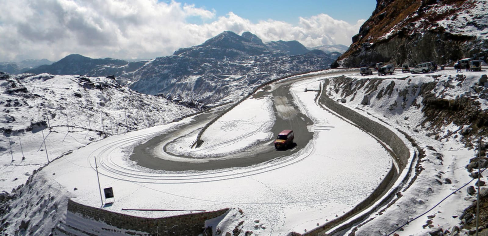 The Indo-China border gate at Nathu La Pass in Sikkim with snow-covered Himalayan peaks and military outposts