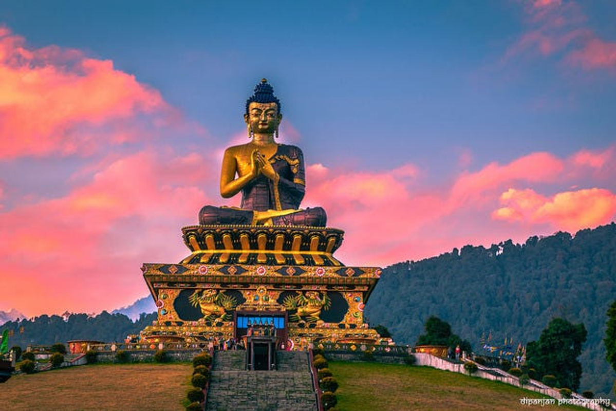  Golden Buddha statue at Buddha Park Ravangla during a misty sunrise.