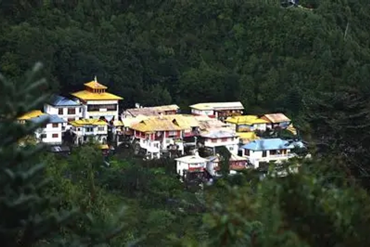 Buddhist nuns in maroon robes at the Brahma-dung-chung Ani Gompa, overlooking the panoramic Tawang Valley.