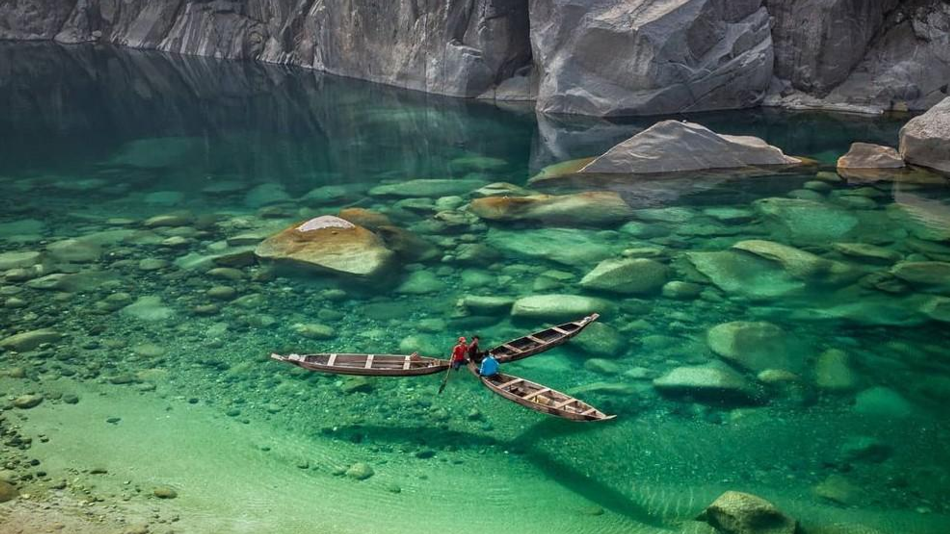 Crystal clear Umngot River at Dawki Meghalaya with boat floating on transparent water near India Bangladesh border