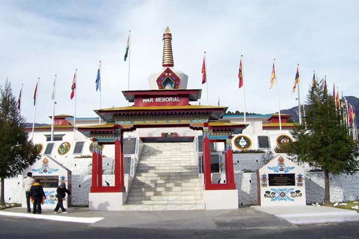 Tawang War Memorial stupa-style architecture against snow-covered Himalayan mountains