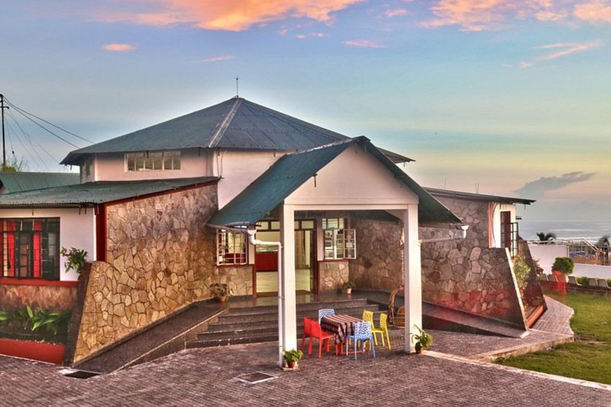  A cozy homestay or boutique resort in Cherrapunji overlooking a lush valley or waterfall