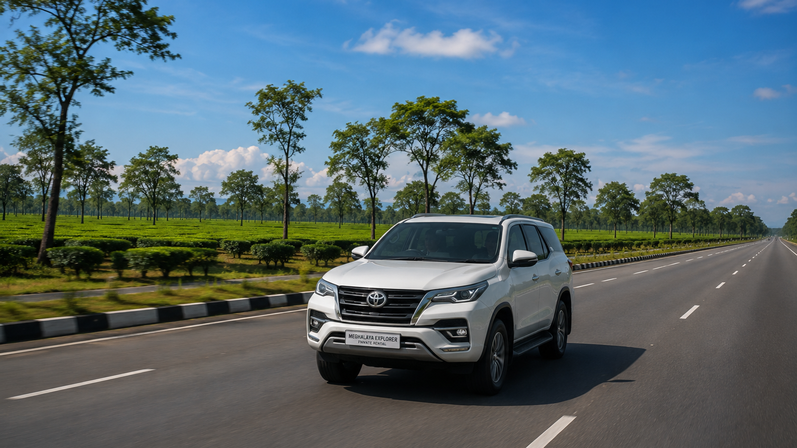 A private rental SUV cruising smoothly on the flat national highway stretch with tea gardens in the background moving from Kaziranga to Shillong