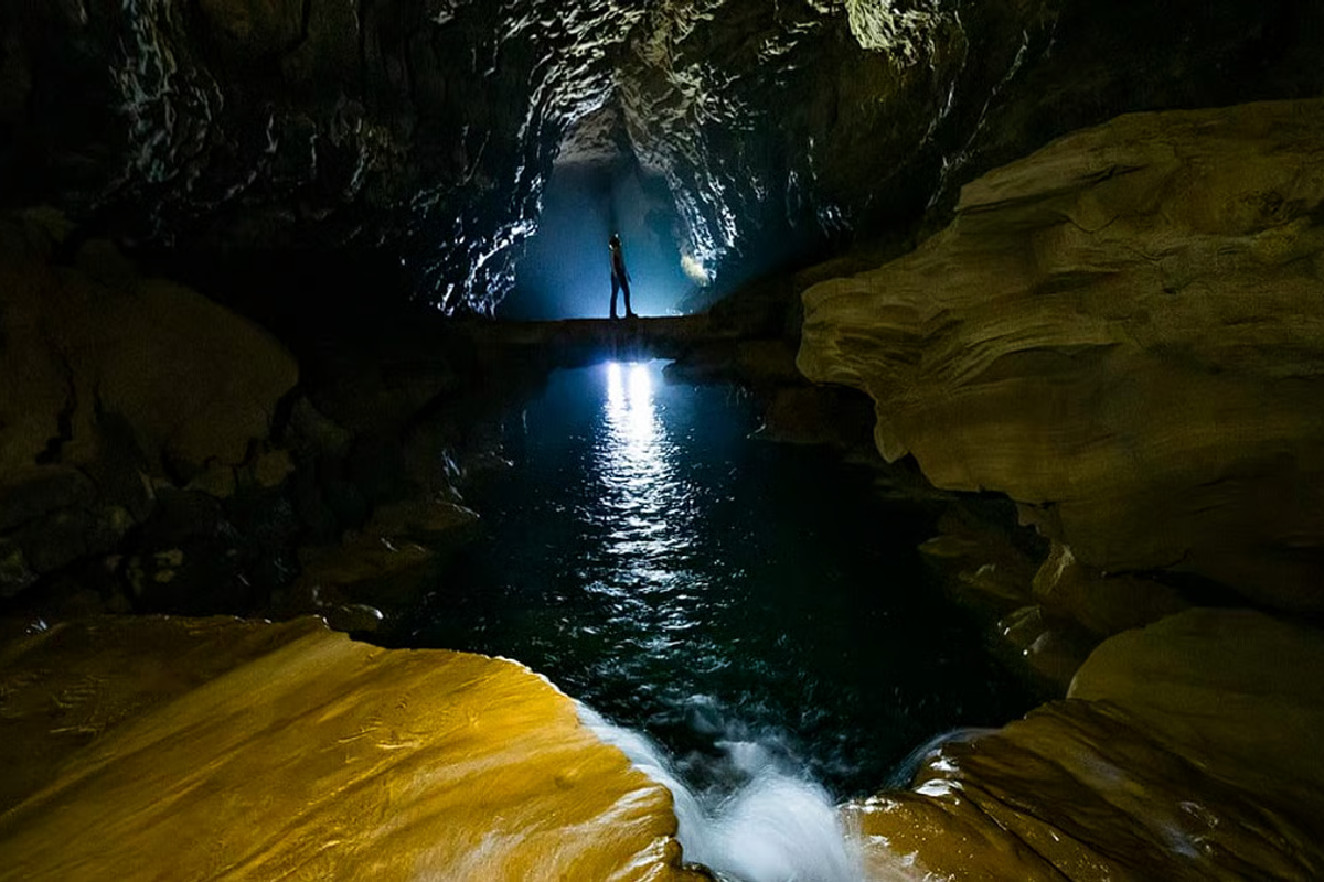 Crystal clear turquoise water pools and natural limestone dams inside Krem Chympe cave Meghalaya.