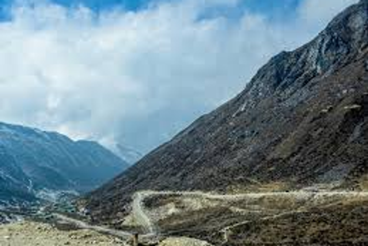 A high-clearance SUV navigating the mountain roads of Sela Pass at 13,700 feet in Arunachal Pradesh.