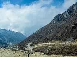 A high-clearance SUV navigating the mountain roads of Sela Pass at 13,700 feet in Arunachal Pradesh.