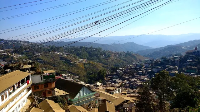 Kohima town houses spread across green hills in winter morning light