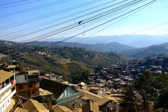 Kohima town houses spread across green hills in winter morning light