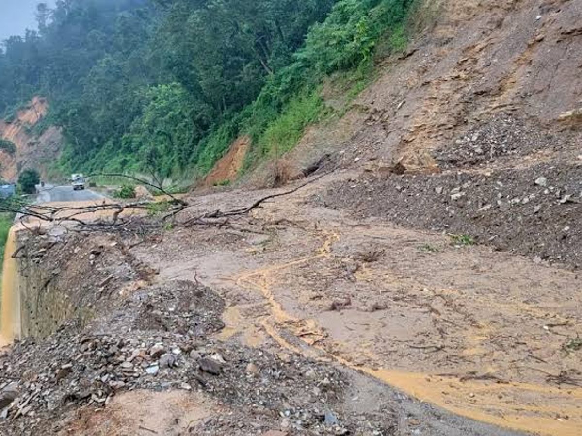 Vehicles on a wet Himalayan road during monsoon conditions