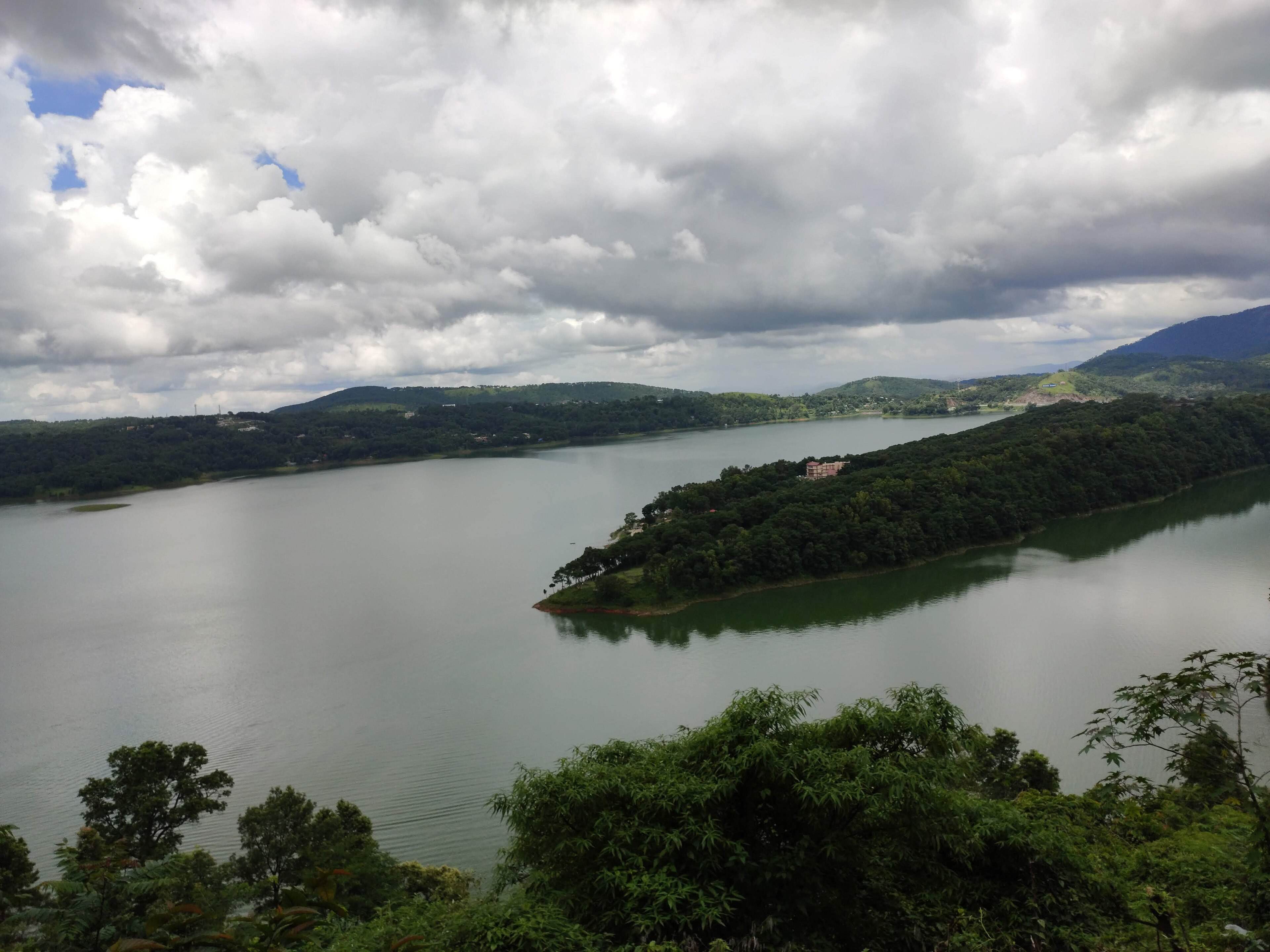 Clouds over Umiam Lake and its wooded island