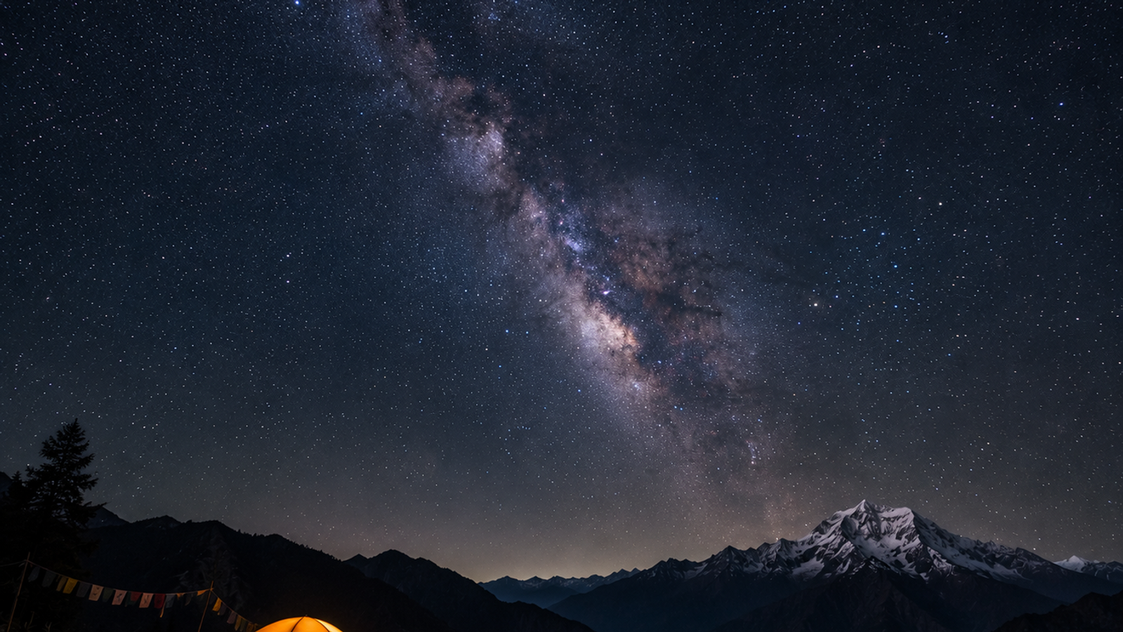 "Cinematic long-exposure of the Milky Way galaxy over a dark mountain silhouette and a glowing orange tent in Arunachal Pradesh."