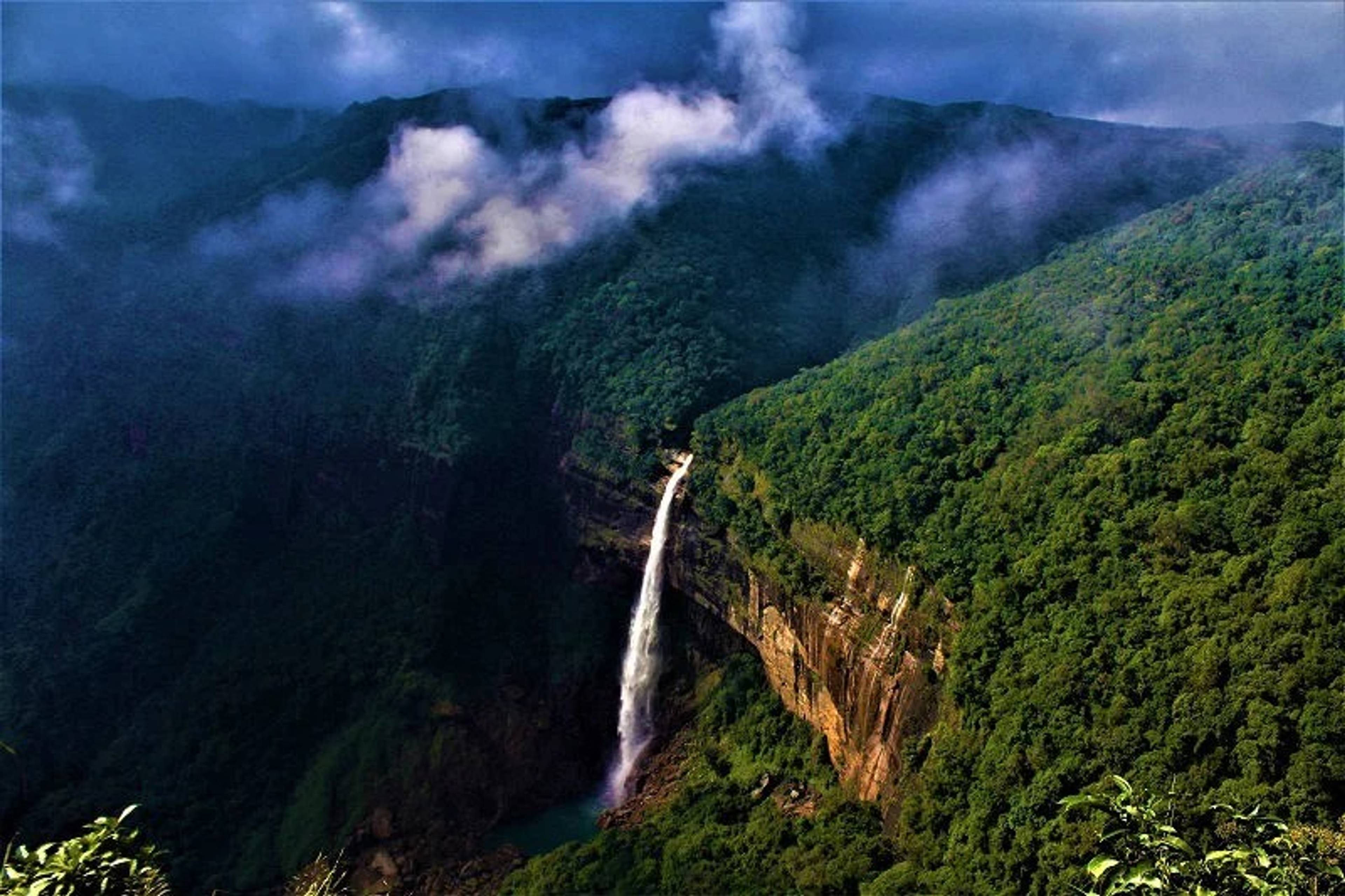 Tall waterfall plunging from a cliff in Cherrapunji.