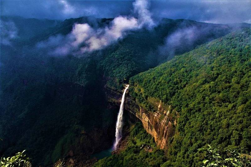 Tall waterfall plunging from a cliff in Cherrapunji.