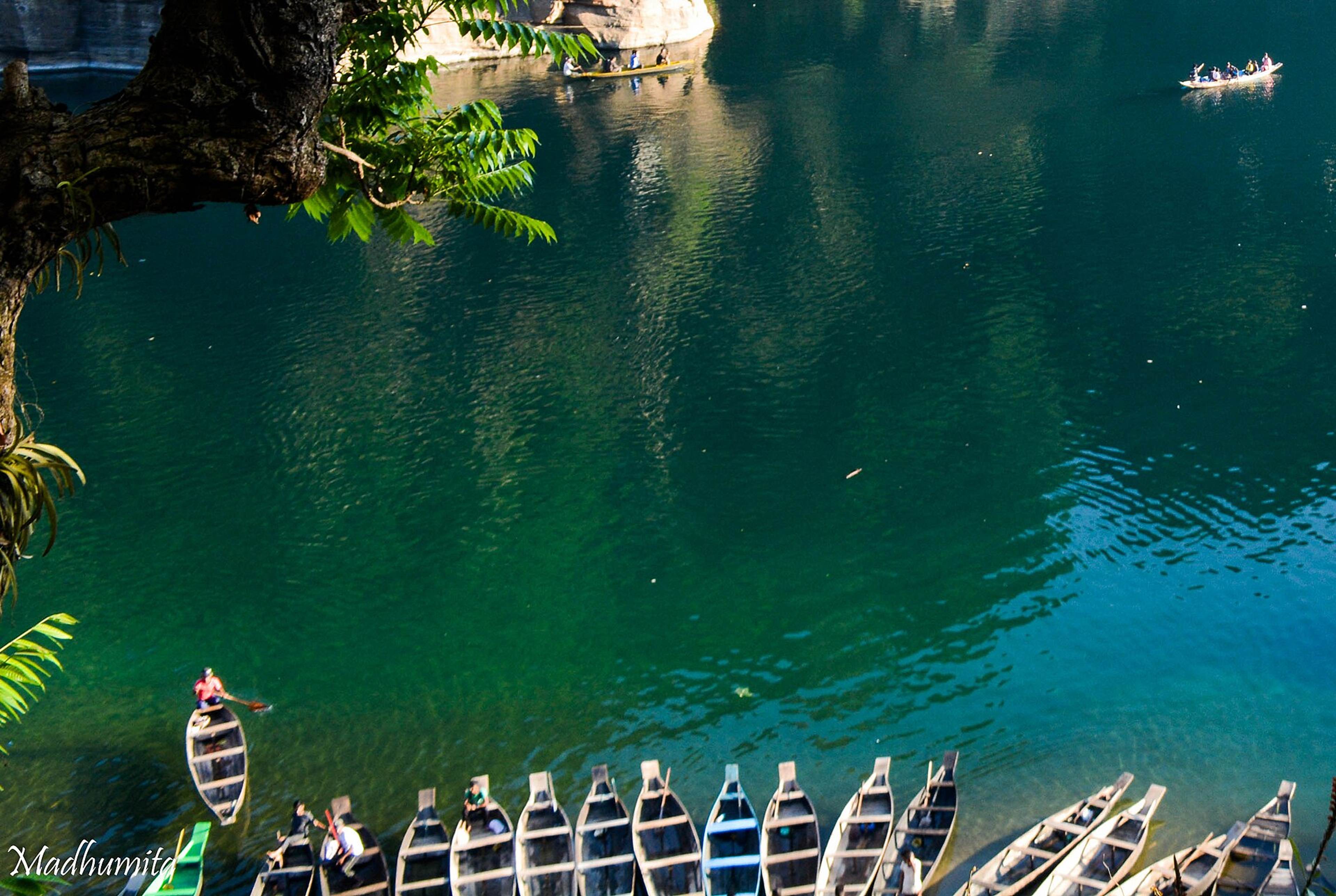 Wooden boats on the clear green Umngot river in Meghalaya