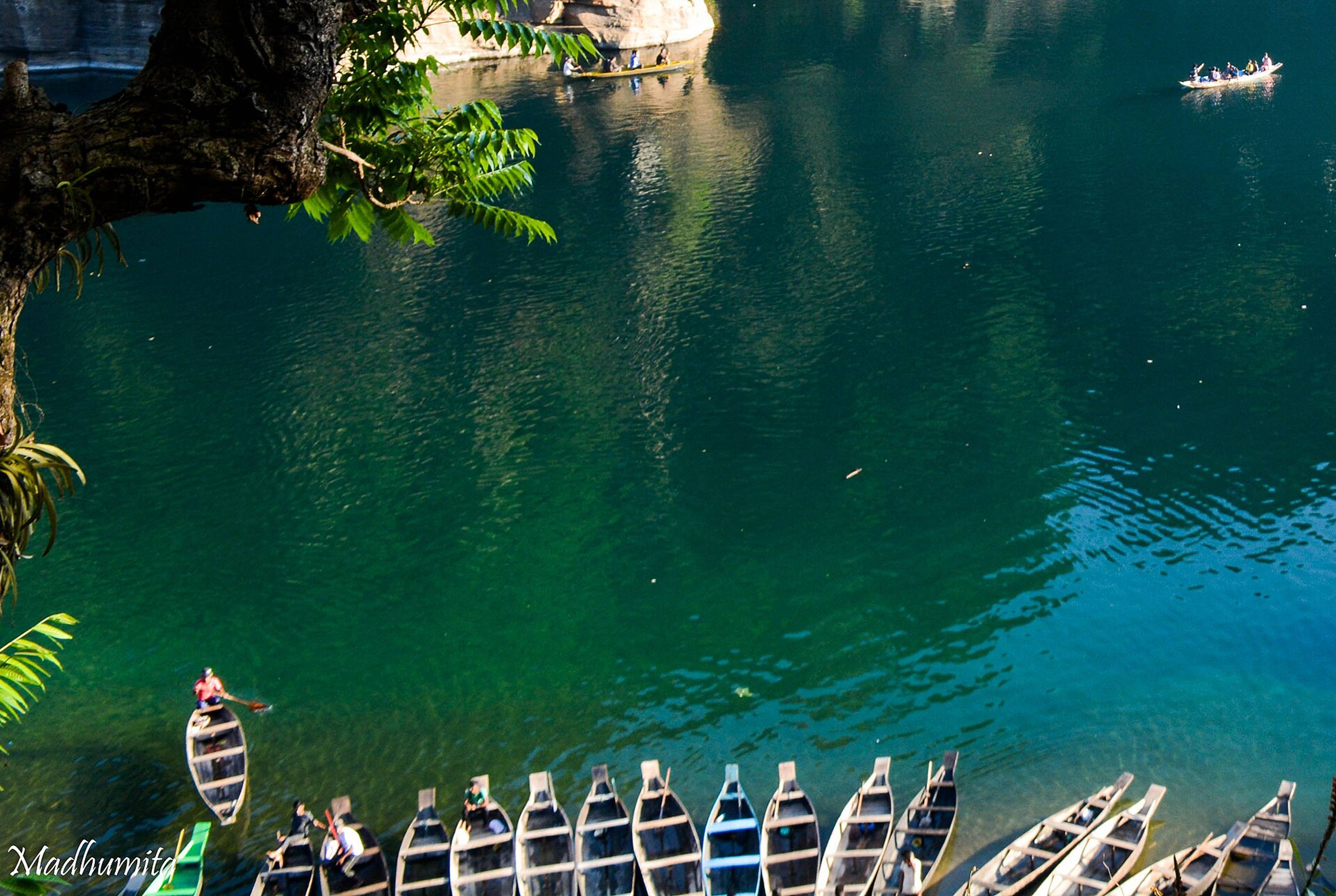 Wooden boats on the clear green Umngot river in Meghalaya