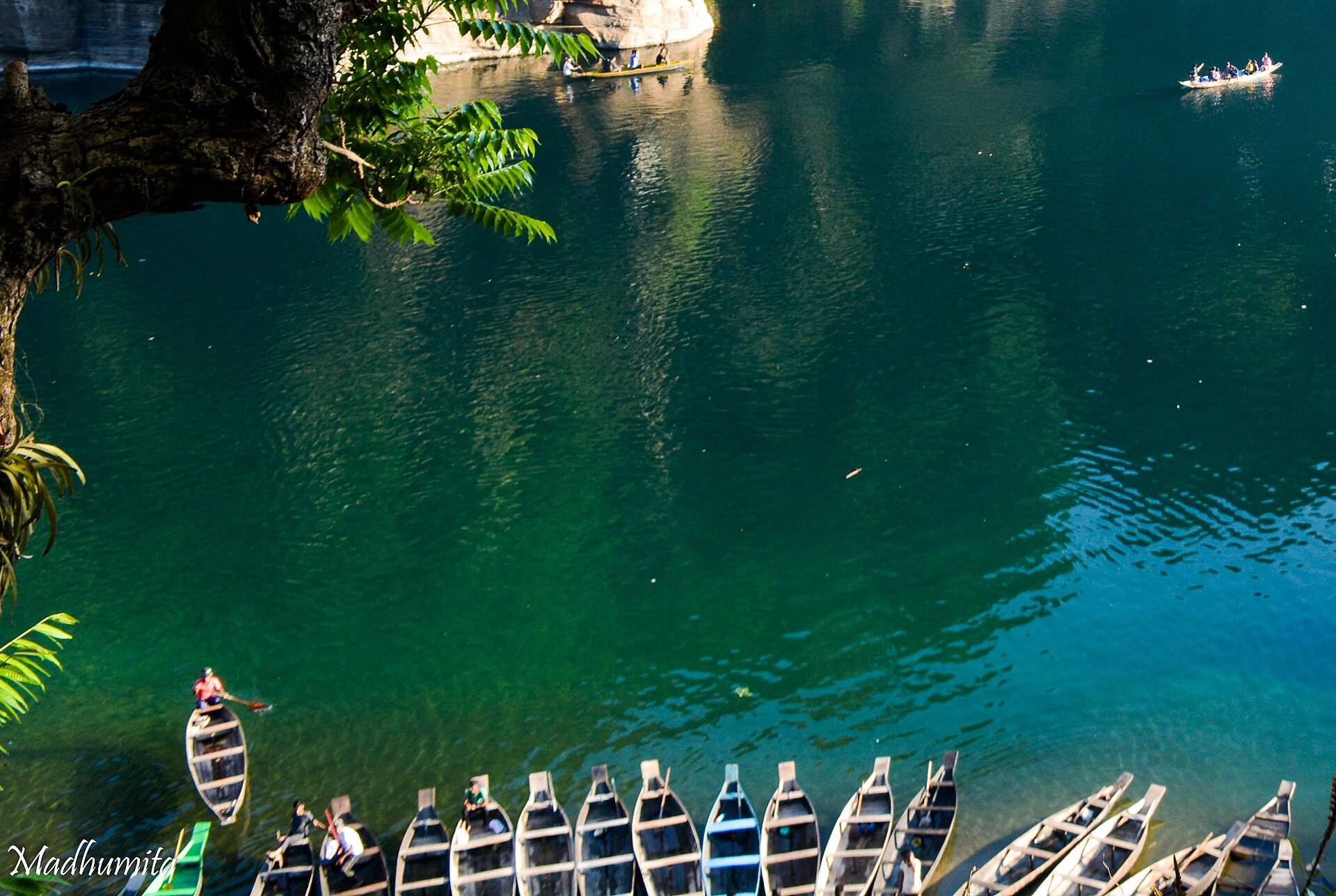 Wooden boats on the clear green Umngot river in Meghalaya