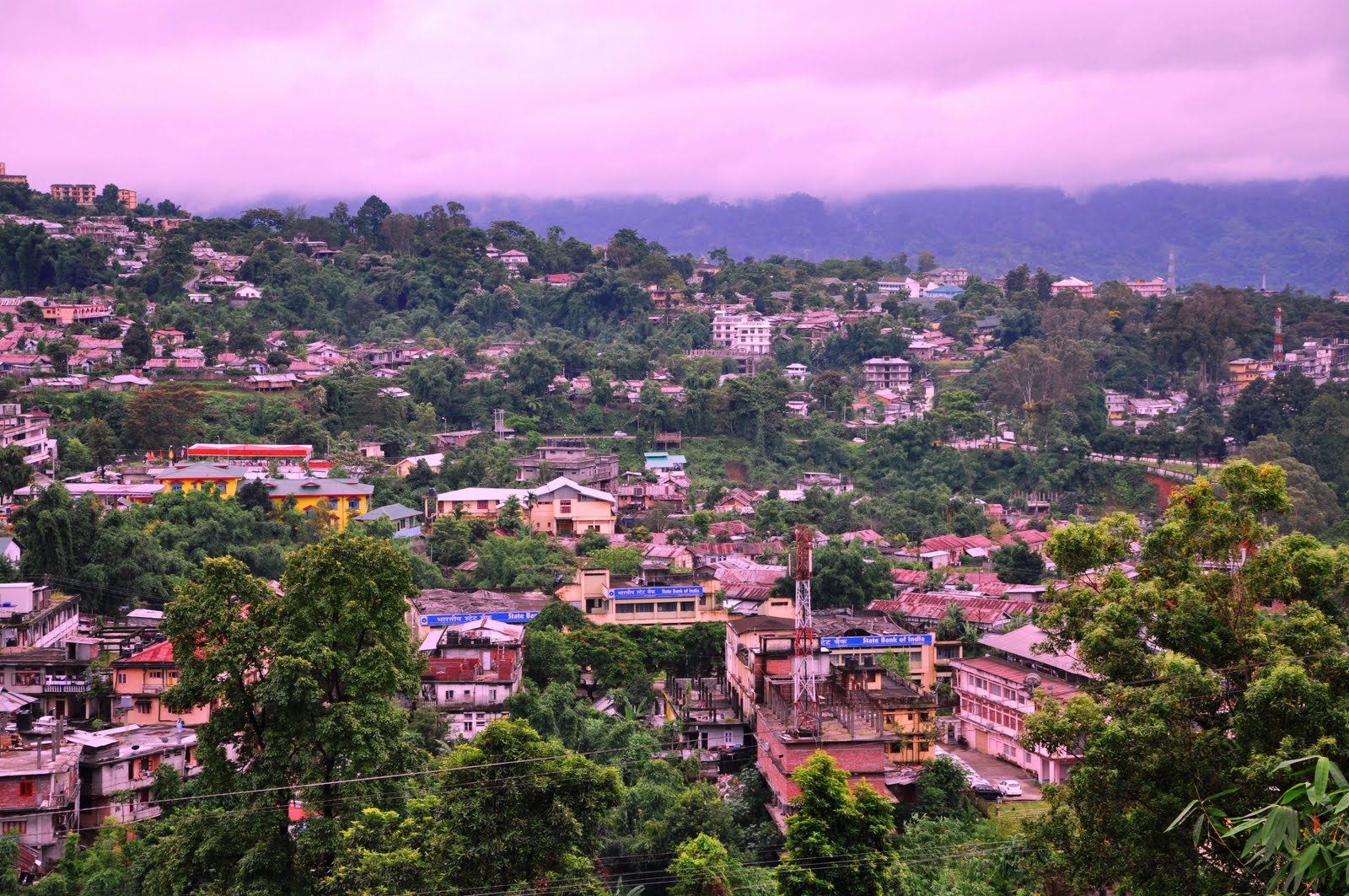Panoramic aerial view of Itanagar city Arunachal Pradesh with rolling green hills and misty Himalayan foothills.