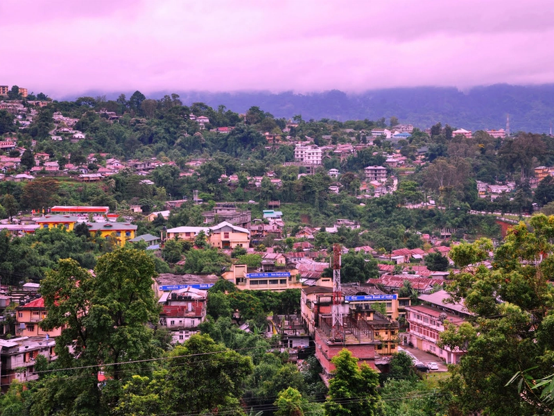 Panoramic aerial view of Itanagar city Arunachal Pradesh with rolling green hills and misty Himalayan foothills.