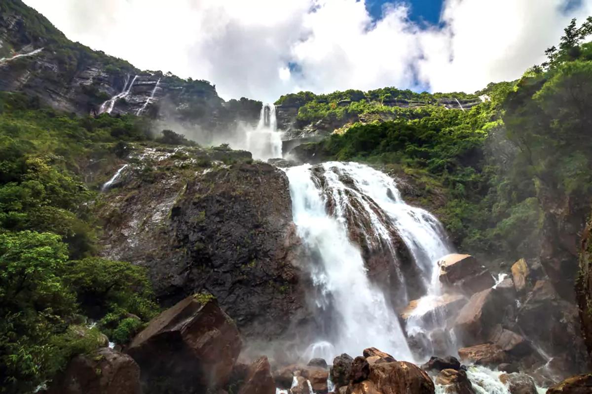 Three-staged Kynrem Falls in Thangkharang Park Meghalaya being the 7th highest waterfall in India.