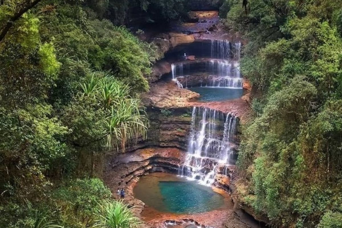 Three-tiered circular Wei Sawdong waterfall in Cherrapunji hidden in deep tropical forest.